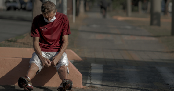 Man with mask sitting